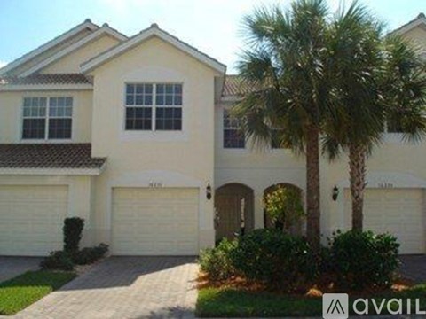 A house with a palm tree in front of it.