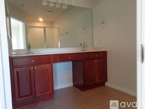 A bathroom with a vanity and a mirror.