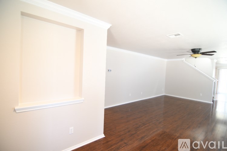 A room with a ceiling fan and a window.