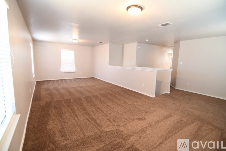 A room with a carpeted floor and white walls.