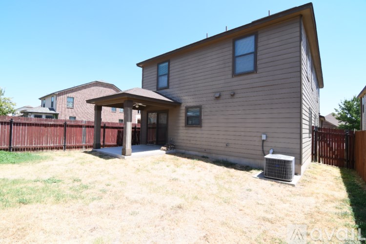 A house with a brown fence and a brown roof.