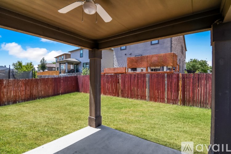 A house with a covered patio and a ceiling fan.
