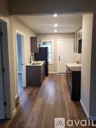 A kitchen with wooden floors and modern appliances.