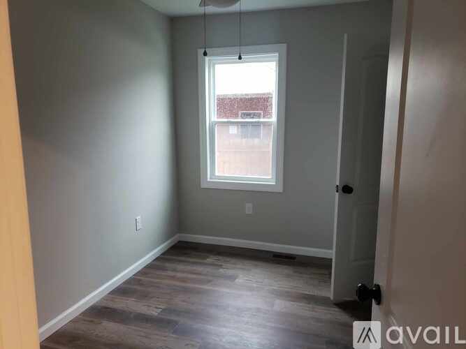 A room with a window and a door.