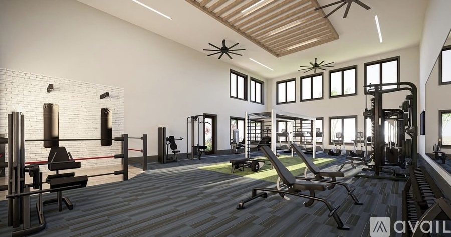 A gym with a variety of equipment including treadmills, weights, and exercise machines.