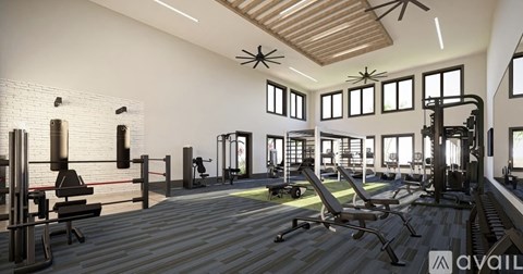 A gym with a variety of equipment including treadmills, weights, and exercise machines.