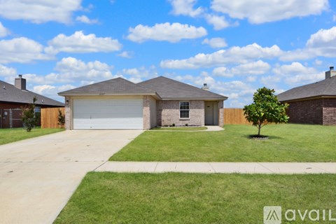 A house with a garage is for sale.