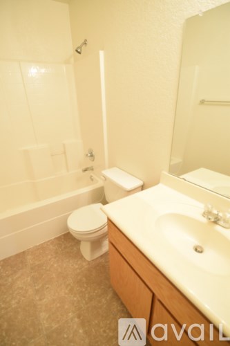 A bathroom with a toilet, sink and bathtub.