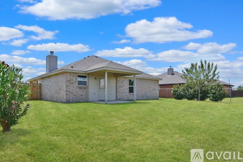 A house with a tree in front of it.