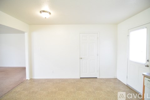 A room with a door and a window.