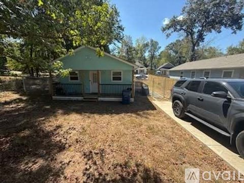 A blue house with a tree in front of it.