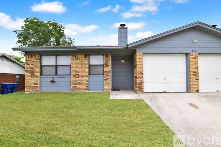 A house with a grey roof and a garage door.