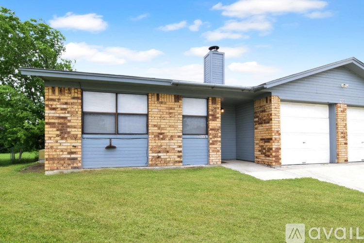 A house with a blue garage door is for sale.