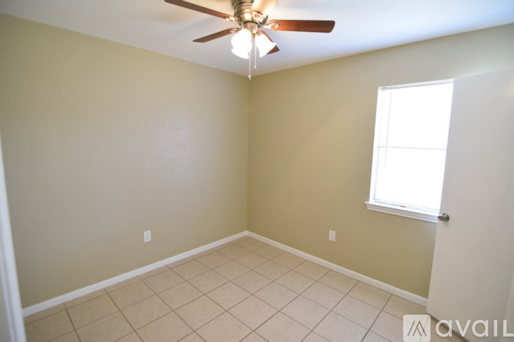 A room with a ceiling fan and a window.