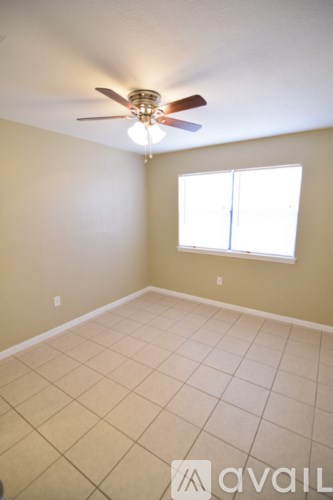 A room with a ceiling fan and a window.