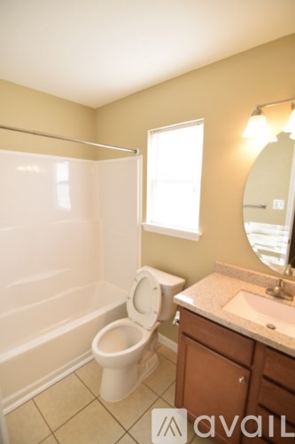 A bathroom with a toilet, sink, and shower.