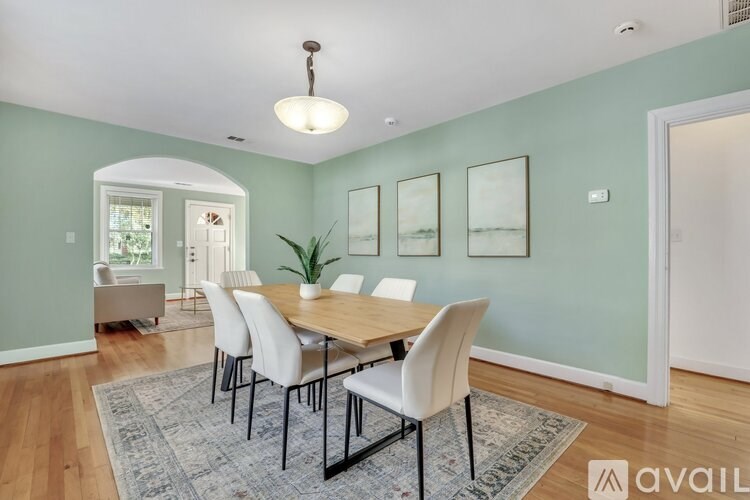 A dining room with a table and chairs.
