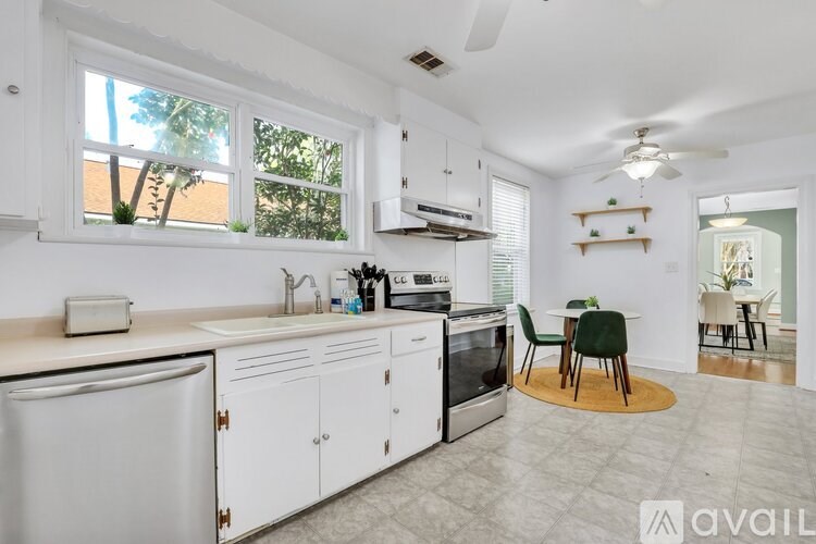 A kitchen with white cabinets and a sink.