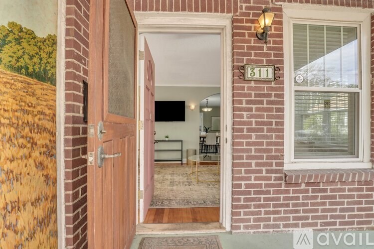 A house number 311 with a brown door and a window.