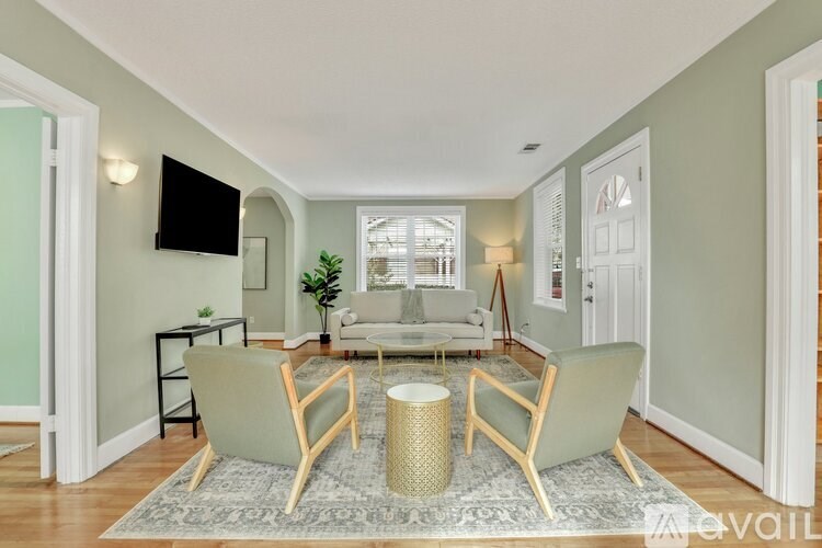 A living room with a grey couch and a coffee table.