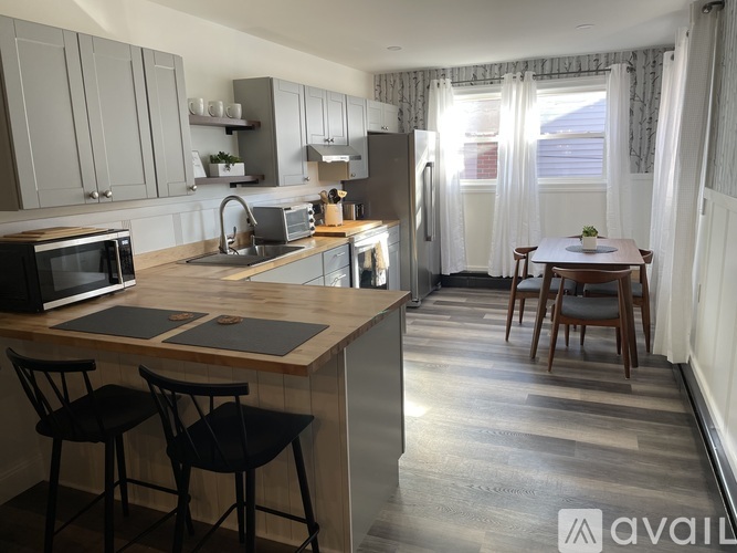 A kitchen with a table and chairs in the middle of the room.