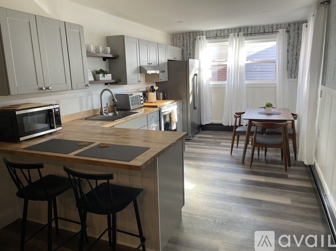 A kitchen with a table and chairs in the middle of the room.