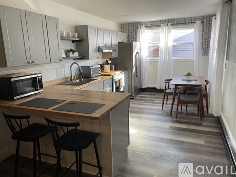 A kitchen with a table and chairs in the middle of the room.