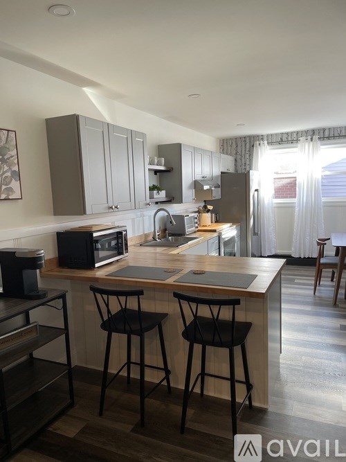 A kitchen with a bar stool and a countertop.