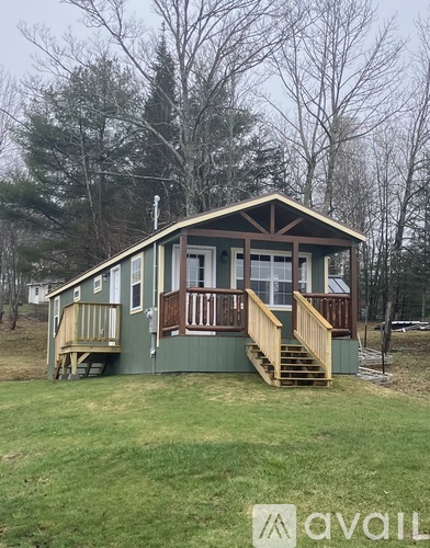 A small house with a porch and a deck.