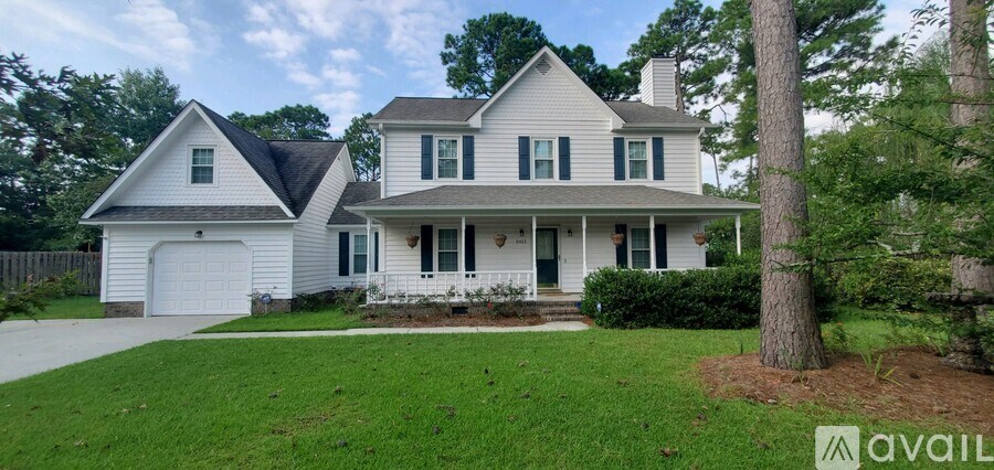 A two-story house with a garage is for sale.