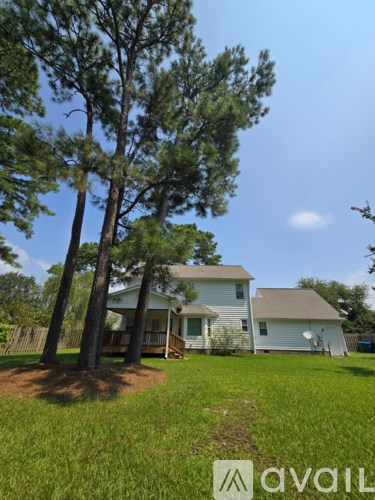 A house with a tree in front of it.
