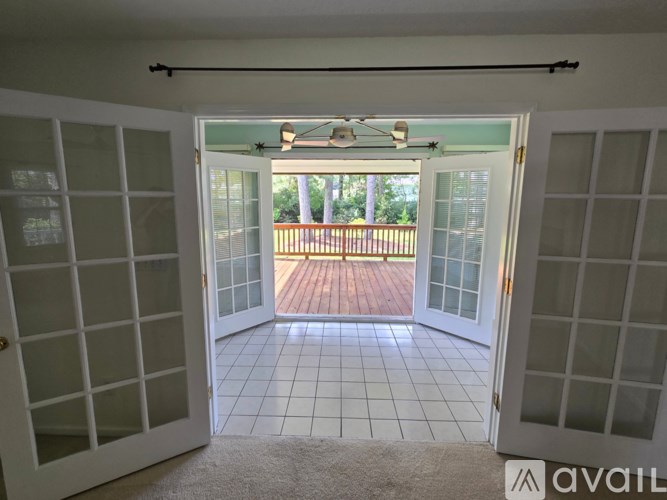 A room with a sliding glass door leading to a deck.