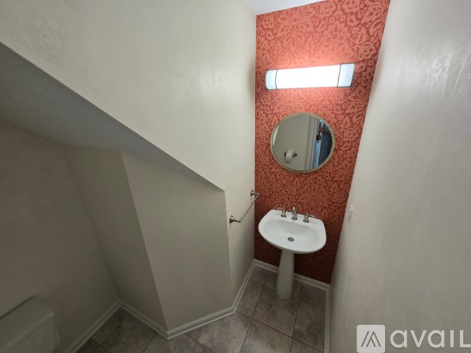 A small bathroom with a sink and mirror.