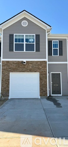 A grey house with a white garage door.