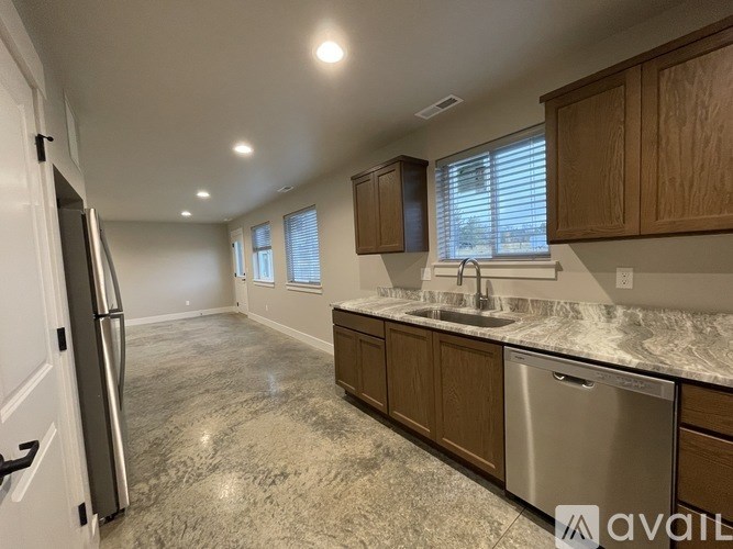 A kitchen with granite countertops and stainless steel appliances is available for rent.