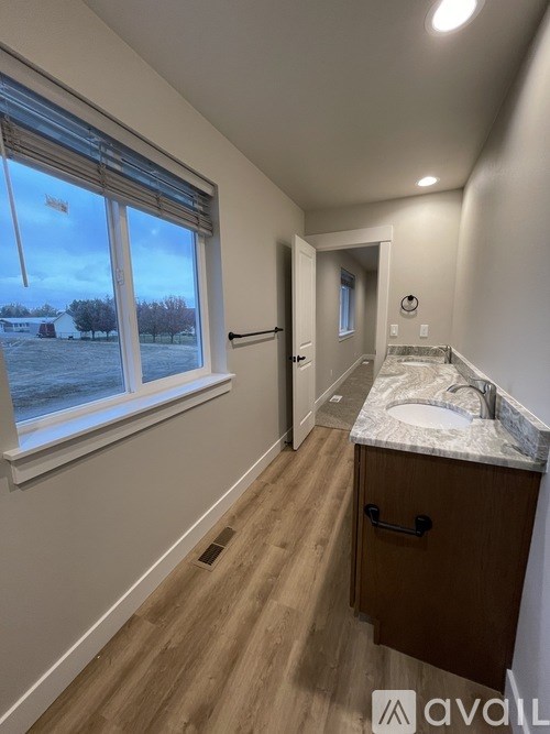 A bathroom with a window overlooking a snowy landscape.