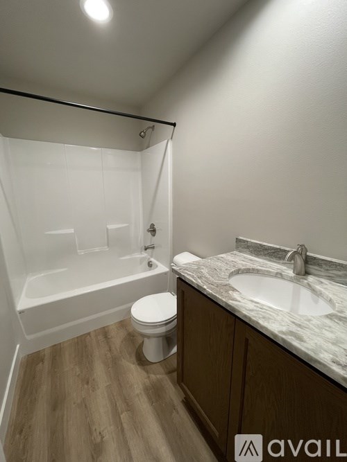 A bathroom with a toilet, sink, and bathtub.