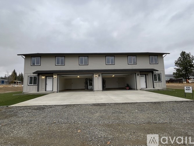 A two-story house with a garage is for sale.