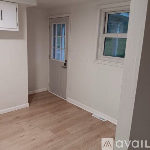 A room with a white door and a window with a white frame.