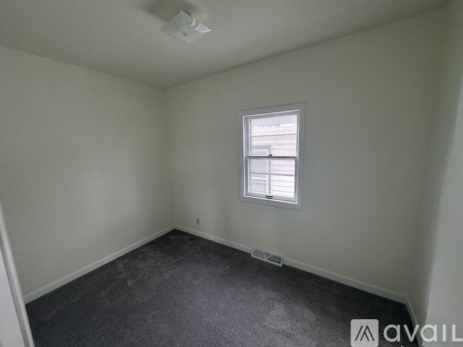 A room with a window and a ceiling fan.