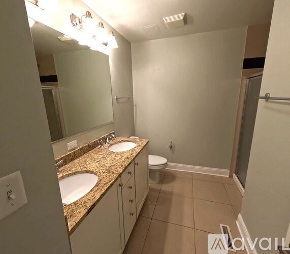 A bathroom with a sink, mirror, and toilet.