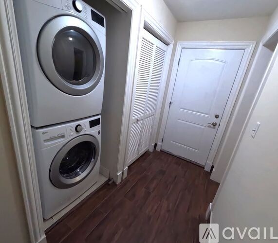 A small laundry room with a washer and dryer.