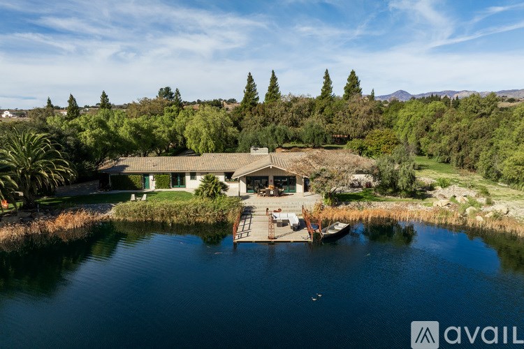 A house is surrounded by water and trees.