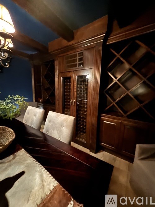 A bedroom with a bed, chair, and a fan.