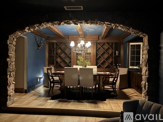 A spacious living room with a couch, a coffee table, and a ceiling fan.
