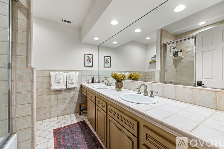 A bathroom with a white sink and a mirror.