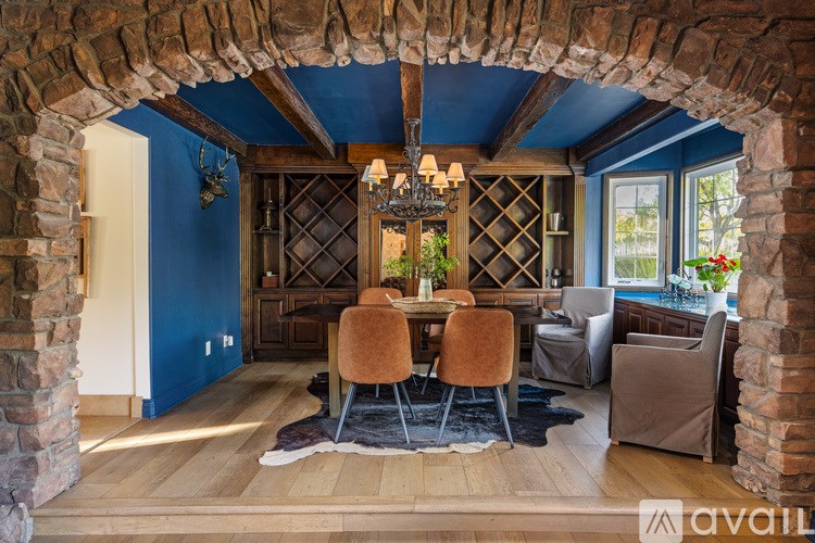 A dining room with a wooden table and chairs.