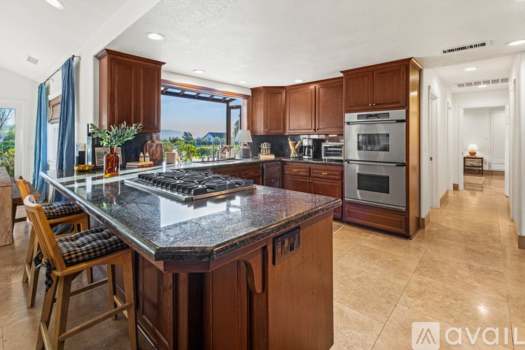 A modern kitchen with a large island and wooden cabinets.