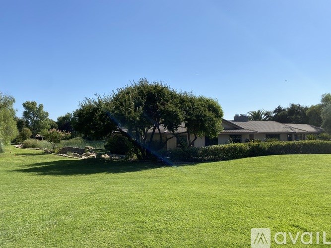 A house with a tree in front of it.