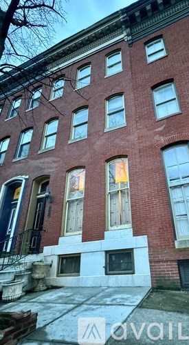 A red brick building with a white window in the center.
